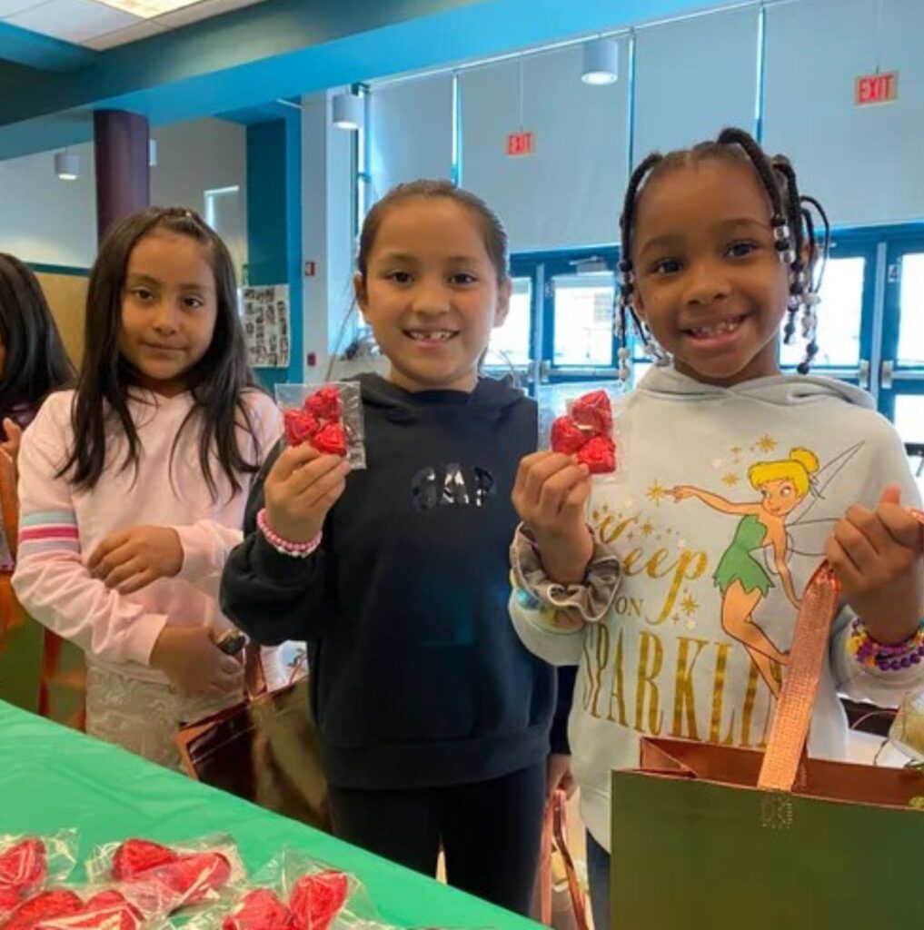 Children holding gifts and smiling